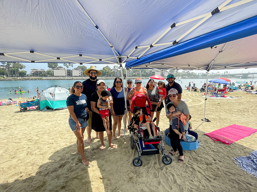 Group of people standing at the beach.